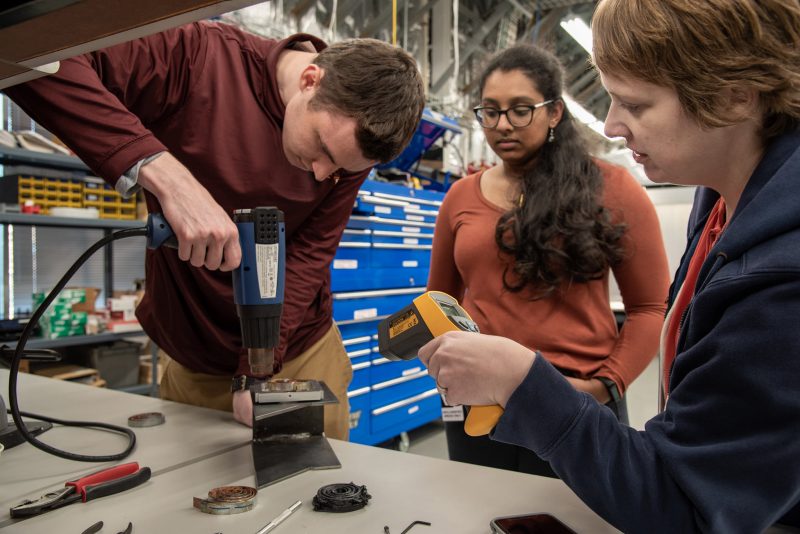 Picture of Mechanical Engineering students working on prototype at Aerospace labs.