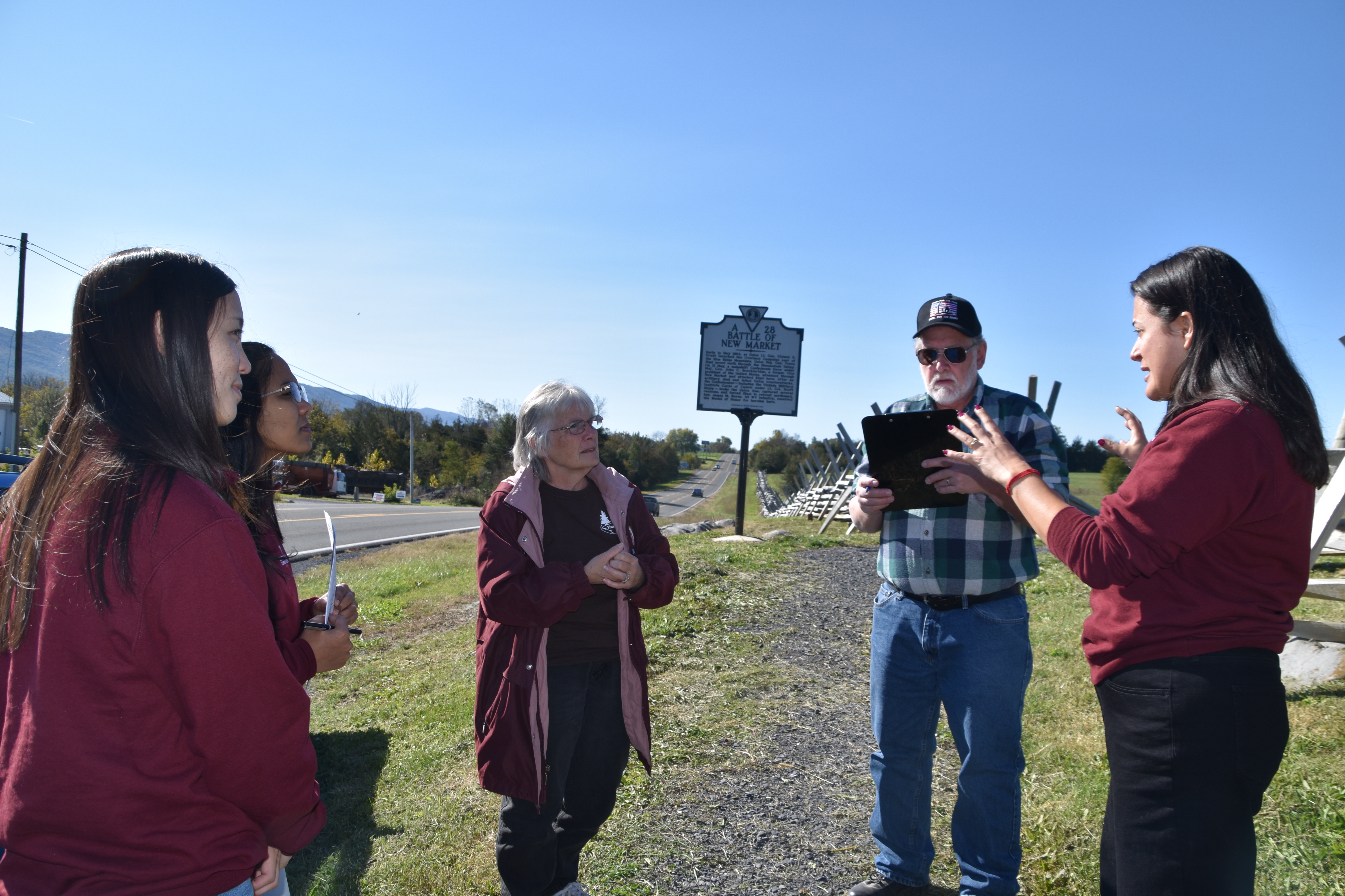 Senior Economic Development Specialist and Graduate Assistants Katie Lee and Sadhana Manthapuri speak to tourists visiting the Battle of New Market site.